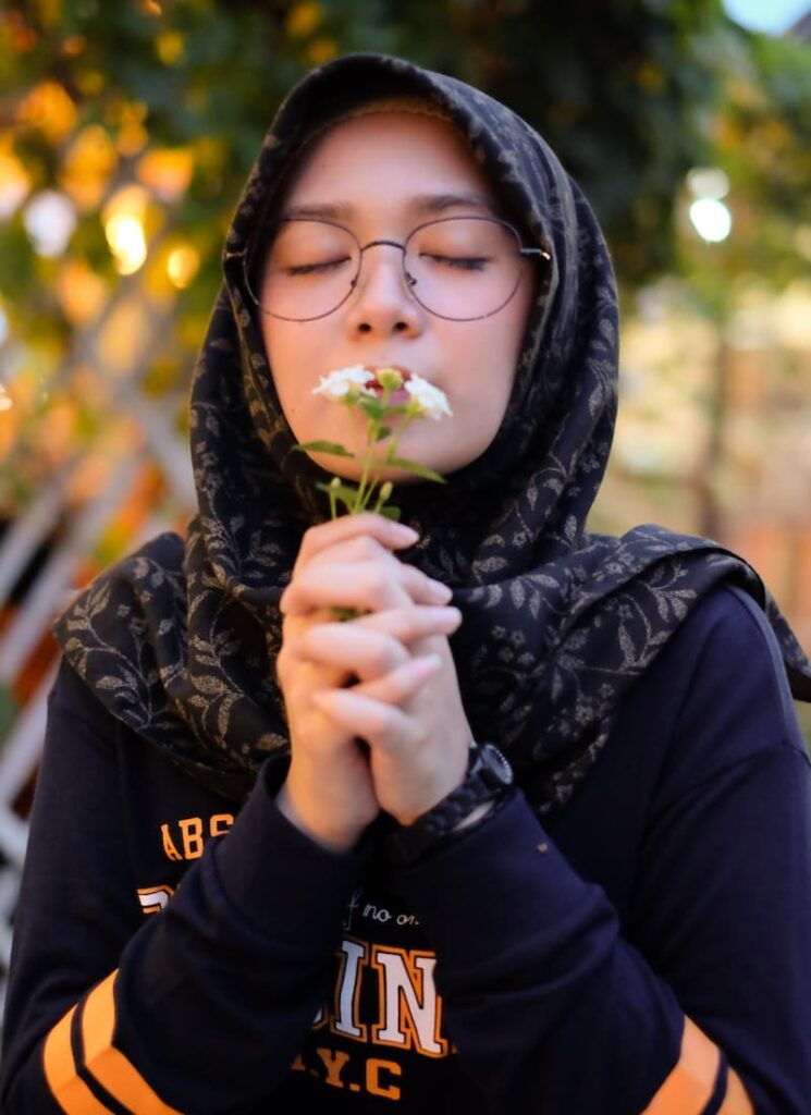 mulher sentindo cheiro a flores do nanda